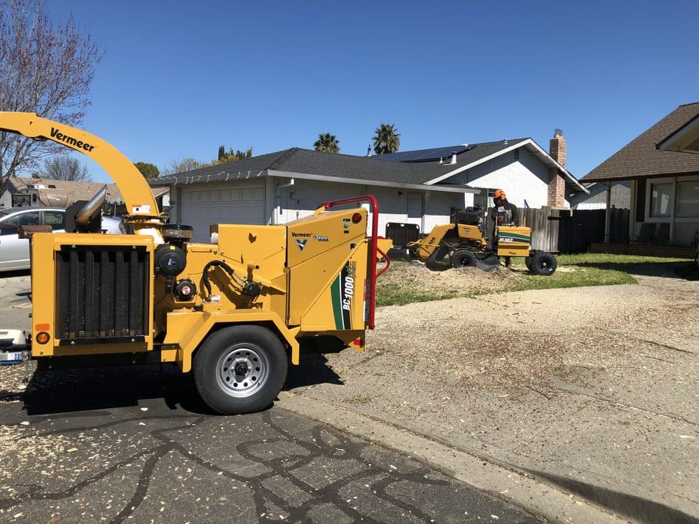 Tree service equipment at a residential jobsite by J C Garden Tree Service.