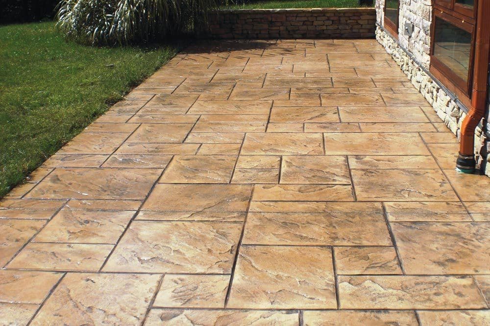 Stamped concrete patio and walkway by J C Garden Tree Service.