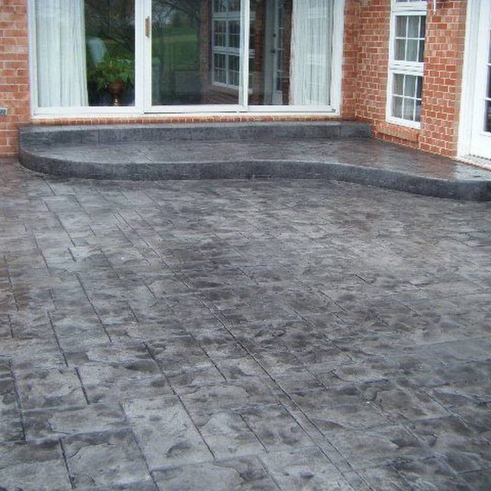 Stamped concrete driveway and paved surface by J C Garden Tree Service.